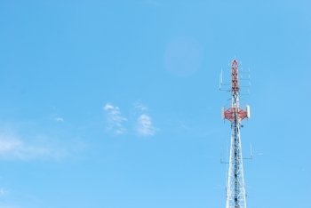 photo of a communication tower against blue sky background
