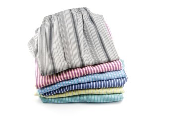 pile of stripped boxer shorts (male underwear) isolated on white background