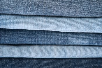 stack of blue jeans as a background or texture