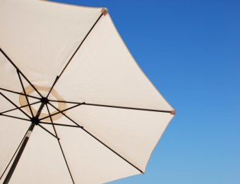 beach or pool outdoor umbrella against a gorgeous blue sky background