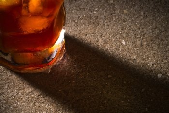 a glass of whiskey with a close-up on the marble table