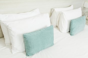 White and green pillows on bed