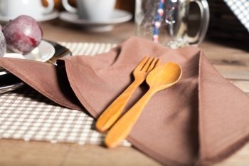 Wooden spoon and fork Placed on the napkin. Set the table