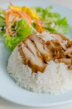 close up fried Chicken over steamed rice on plate