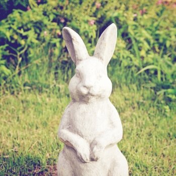 Statue of rabbit in the garden with retro filter effect