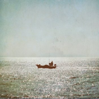 The silhouette of fisherman with boat in the sea vintage background