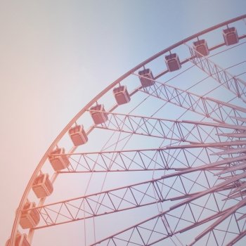 Ferris wheel with blue sky with retro filter effect