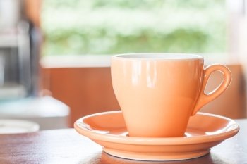 Still life with orange espresso coffee cup, stock photo