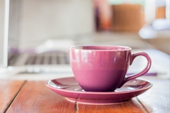 Purple coffee cup on work station, stock photo