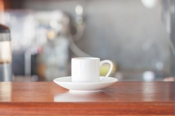 Mini white coffee cup in coffee shop, stock photo