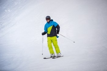 Professional skier riding the downhill on ski resort