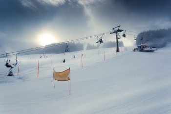 Beautiful landscape of Alpine ski slope with working ski lift