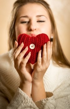 Closeup portrait of woman blowing kiss and red heart