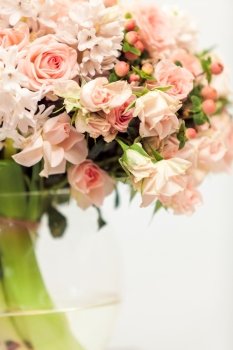 Closeup photo of pastel pink flowers against white background