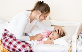 Young brunette mother waking up sleeping daughter at morning