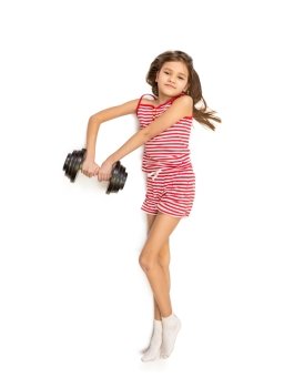 Funny isolated photo of little girl lying on floor and lifting dumbbell
