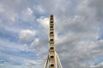 Ferris wheel with blue sky and cloud