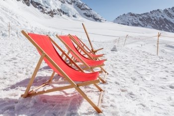 View of Empty red beds on the snow, relaxing concept