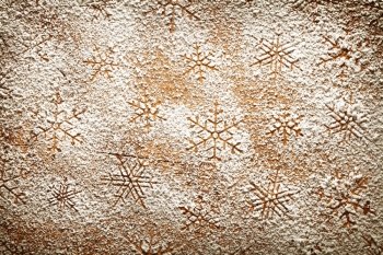 Christmas background with snowflakes. Snowflake pattern made ??of icing sugar on wooden table. Top view