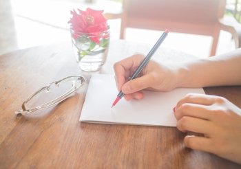 Writing love letter on romantic table, stock photo