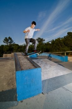 Skateboarder on a slide at the local skatepark.