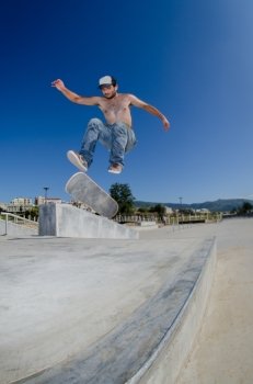Skateboarder on a flip trick at the local skatepark.