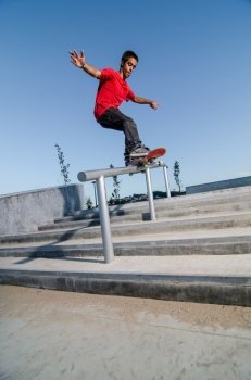 Skateboarder doing a FS Feeble on rail.
