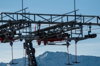 Detail of T-bar ski lift (drag lift) against great bkue sky
