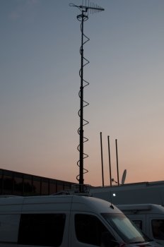 White broadcast trucks recording and broadcasting a live event