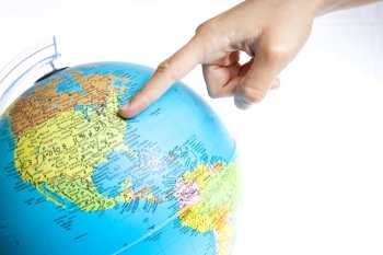 Finger pointing United States on the global map