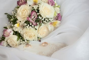 wedding still life. bridal bouquet and the ring