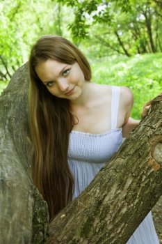 attractive girl standing near tree. outdoor shot