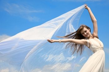 attractive girl with flying material. outdoor shot