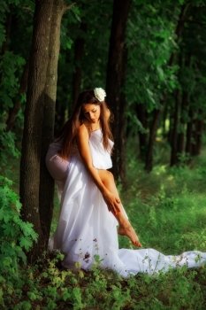 girl wrapped in white fabric. outdoor shot