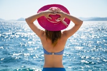 Beautiful woman with hat at the beach