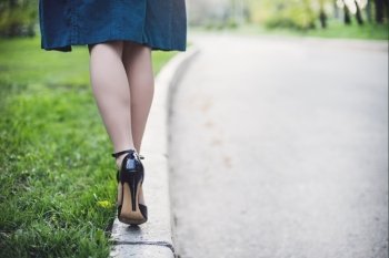 Woman legs and high heels in the park