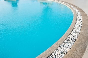 Swimming pool with white pebbles in edge