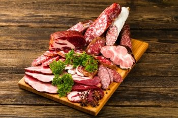 sausage, meat, vegetables and spices on wooden background