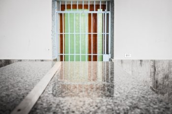 Barred and colorful  door with reflection on granite table