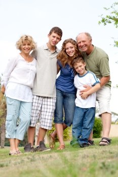 Full length portrait of a happy family standing outdoor
