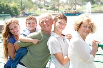 Closeup portrait of a happy family standing together in outdoor