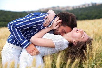 Men and woman hugging in the meadow