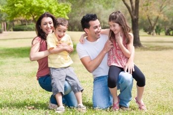 Close up of a Happy family enjoying in a park with their children