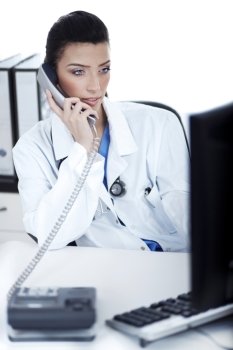 Attractive female doctor making phone call with the patient, white background studio shot