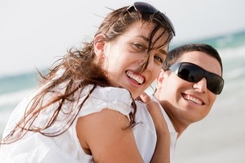 playful young couple look back and smiling on the beach,outdoor