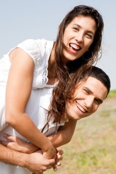 Side view of Smiling young couple piggybacking