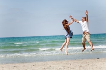 Happy young couple having fun on the beach