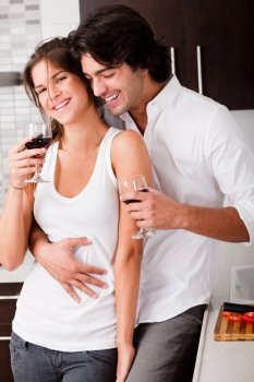 couple ready to drink their wine in kitchen