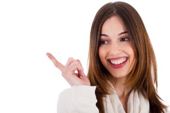 attractive female model smiling and pointing her finger at copy space on white background