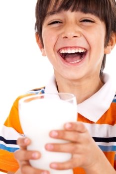 Smiling young boy holding a glass of milk over a isolated white background